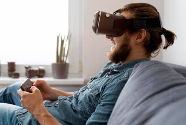 man with vr glasses holding phone