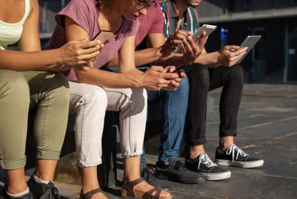 people using gadgets outdoors