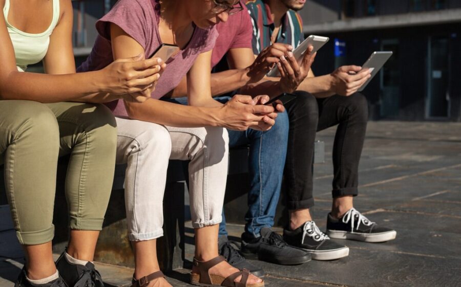 people using gadgets outdoors