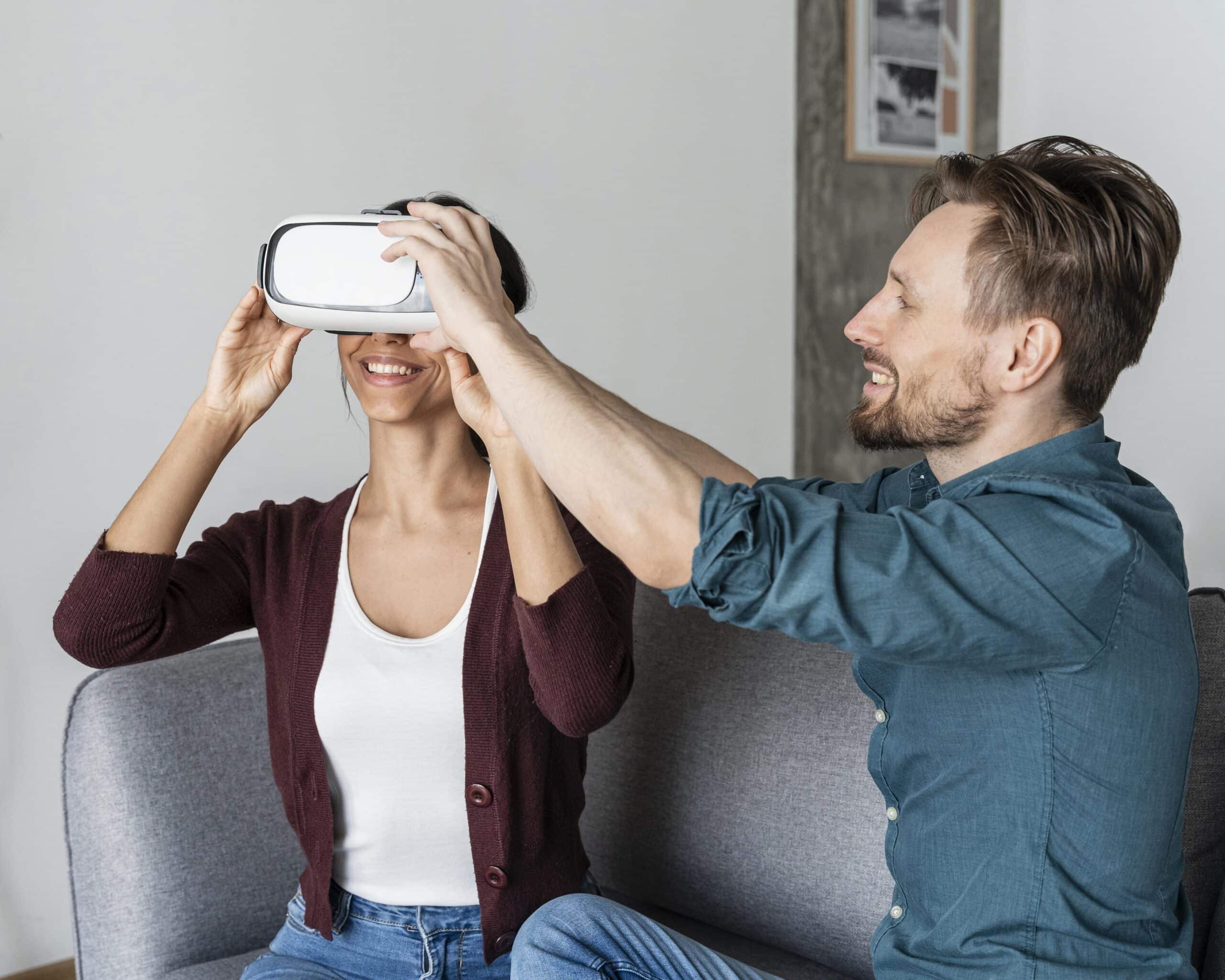 Man helping woman put on virtual reality headset